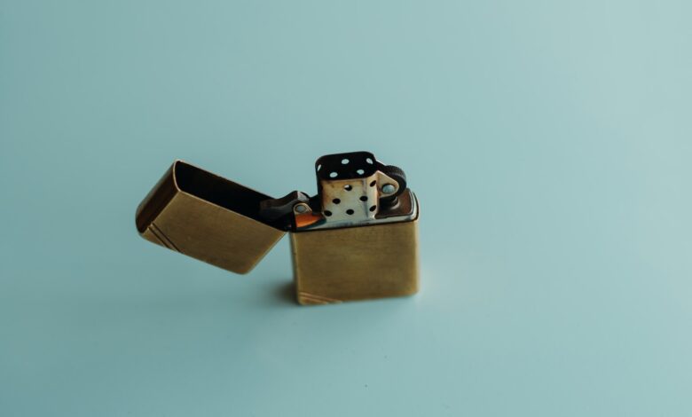 silver flip lighter on white surface